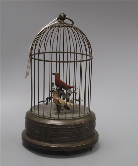 A clockwork musical singing bird automaton, the brass cage containing two birds with metal foliage, H 30cm